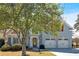 Attractive home featuring a well-maintained lawn, mature trees, and a two-car garage, radiating a welcoming atmosphere at 2445 Ridgelake Dr, Villa Rica, GA 30180