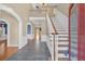 Welcoming foyer with hardwood floors, a staircase, and archways leading to other rooms, showcasing elegant design at 2445 Ridgelake Dr, Villa Rica, GA 30180