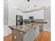 Well-lit kitchen featuring a gray island and stainless steel appliances at 2445 Ridgelake Dr, Villa Rica, GA 30180