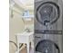 Efficient laundry room with stacked washer/dryer and utility sink for added convenience at 2445 Ridgelake Dr, Villa Rica, GA 30180