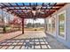 Outdoor patio area with pergola and stone and wooden deck flooring at 2445 Ridgelake Dr, Villa Rica, GA 30180