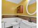 Charming powder room with wainscoting, wooden accents, and stylish fixtures at 2445 Ridgelake Dr, Villa Rica, GA 30180