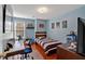 Bedroom with hardwood floors, a blue accent wall, and a window at 4342 Richmond Nw Pl, Acworth, GA 30101