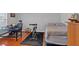 Bonus room featuring desk, spin bike and bed with hardwood floors and lots of natural light at 4342 Richmond Nw Pl, Acworth, GA 30101