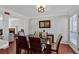 Bright dining room with hardwood floors, modern light fixture and view into living room at 4342 Richmond Nw Pl, Acworth, GA 30101