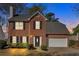 Beautiful two-story brick home with an attached two-car garage and trimmed hedges at 4342 Richmond Nw Pl, Acworth, GA 30101