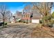 View of the brick home, driveway and partial view of adjacent houses at 4342 Richmond Nw Pl, Acworth, GA 30101