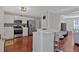Bright kitchen featuring stainless steel appliances, breakfast bar, and hardwood floors at 4342 Richmond Nw Pl, Acworth, GA 30101