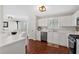 Well-lit kitchen with white cabinetry, stainless steel appliances, and hardwood flooring at 4342 Richmond Nw Pl, Acworth, GA 30101