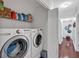 Convenient laundry room with modern washer, dryer, and storage shelves near hallway at 4342 Richmond Nw Pl, Acworth, GA 30101