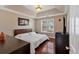 Main bedroom featuring a trey ceiling, a window, and hardwood floors at 4342 Richmond Nw Pl, Acworth, GA 30101