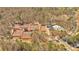 Aerial view of the community tennis courts and a swimming pool surrounded by trees and lush greenery at 4342 Richmond Nw Pl, Acworth, GA 30101