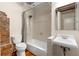 Bright bathroom featuring a shower/tub combo, exposed brick, and a modern vanity at 490 Marietta Nw St # 105, Atlanta, GA 30313