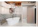 Bright bathroom featuring a freestanding tub and exposed brick at 490 Marietta Nw St # 105, Atlanta, GA 30313