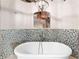 Close up of bright bathroom featuring a freestanding tub, modern tile backsplash, and exposed brick at 490 Marietta Nw St # 105, Atlanta, GA 30313