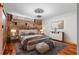 Comfortable bedroom with exposed brick wall, wood floors and modern decor at 490 Marietta Nw St # 105, Atlanta, GA 30313