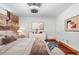 Bedroom features exposed brick wall, wood floors, modern furniture and decor at 490 Marietta Nw St # 105, Atlanta, GA 30313