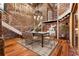 Dining area with exposed brick, modern chandelier, and staircase to a loft space at 490 Marietta Nw St # 105, Atlanta, GA 30313