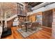 Open-concept dining room featuring exposed brick, modern chandelier, and stairs to a loft area at 490 Marietta Nw St # 105, Atlanta, GA 30313