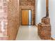 Hallway featuring brick walls and a wooden door with a glass side panel at 490 Marietta Nw St # 105, Atlanta, GA 30313