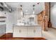Bright kitchen island with stainless steel faucet, custom cabinets, and hardwood floors at 490 Marietta Nw St # 105, Atlanta, GA 30313