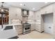 Bright kitchen features stainless steel gas range, custom cabinets, and mosaic backsplash at 490 Marietta Nw St # 105, Atlanta, GA 30313