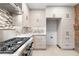 Bright kitchen featuring stainless steel gas range, custom cabinets, mosaic backsplash and exhaust hood at 490 Marietta Nw St # 105, Atlanta, GA 30313