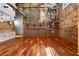 Industrial living area with exposed brick walls, hardwood floors, and modern kitchen at 490 Marietta Nw St # 105, Atlanta, GA 30313