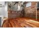 Spacious living area with exposed brick walls, hardwood floors, and industrial-style accents at 490 Marietta Nw St # 105, Atlanta, GA 30313