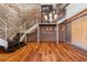 Industrial-style living space featuring exposed brick walls, hardwood floors, and modern staircase at 490 Marietta Nw St # 105, Atlanta, GA 30313