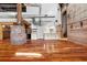 Open-concept living area with modern kitchen, exposed brick, and industrial ductwork at 490 Marietta Nw St # 105, Atlanta, GA 30313