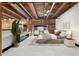 Beautiful main bedroom features exposed brick, wood ceiling beams, and ample natural light at 490 Marietta Nw St # 105, Atlanta, GA 30313