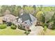Aerial view of a stately home with a three-car garage and a well-maintained green lawn at 500 Poplar Creek Xing, Canton, GA 30114