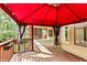 Enjoy this wide and sunny back deck with a red awning and access to the house at 500 Poplar Creek Xing, Canton, GA 30114