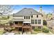 Back of house has a spacious deck, walkout basement, lush yard, and pool perfect for entertaining and relaxation at 500 Poplar Creek Xing, Canton, GA 30114