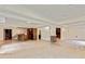 Open basement with tiled flooring, supporting columns, bar area, and ample space for entertainment at 500 Poplar Creek Xing, Canton, GA 30114