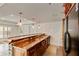 Stylish basement bar boasting a wooden countertop, sink, cabinets, and refrigerator at 500 Poplar Creek Xing, Canton, GA 30114