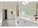 Bright bathroom featuring dual vanities, neutral tile flooring, glass door shower and a door to the walk-in closet at 500 Poplar Creek Xing, Canton, GA 30114