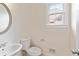 Bright, clean half-bath with white fixtures and a classic round mirror at 500 Poplar Creek Xing, Canton, GA 30114