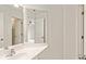 Hall bathroom featuring modern sink and vanity, door to bedroom with ceiling fan, and large mirror at 500 Poplar Creek Xing, Canton, GA 30114