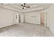 Bright bedroom offering neutral paint, neutral carpet, and tray ceiling with ceiling fan at 500 Poplar Creek Xing, Canton, GA 30114