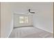 This spacious bedroom features neutral carpet and walls, a ceiling fan and backyard views from the window at 500 Poplar Creek Xing, Canton, GA 30114