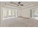 Large bedroom featuring neutral carpeting, natural light, and tray ceiling with ceiling fan at 500 Poplar Creek Xing, Canton, GA 30114