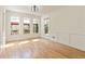 Sunny dining area with hardwood floors and three windows overlooking a patio at 500 Poplar Creek Xing, Canton, GA 30114