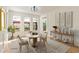 Staged dining room with a round table, modern lighting, and views of the patio at 500 Poplar Creek Xing, Canton, GA 30114