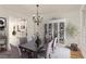Bright dining room featuring modern chandelier, light wood flooring and a white cabinet at 500 Poplar Creek Xing, Canton, GA 30114