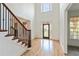 Bright foyer with hardwood floors and a staircase and leaded glass door welcomes visitors at 500 Poplar Creek Xing, Canton, GA 30114