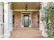 Classic front porch featuring brick walls, white columns, and a stained wooden floor at 500 Poplar Creek Xing, Canton, GA 30114