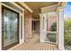 Inviting front porch features brick accents, white columns, and a decorative glass front door at 500 Poplar Creek Xing, Canton, GA 30114