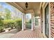 Picturesque front porch with decorative lighting and lush landscaping, creating a welcoming entrance at 500 Poplar Creek Xing, Canton, GA 30114